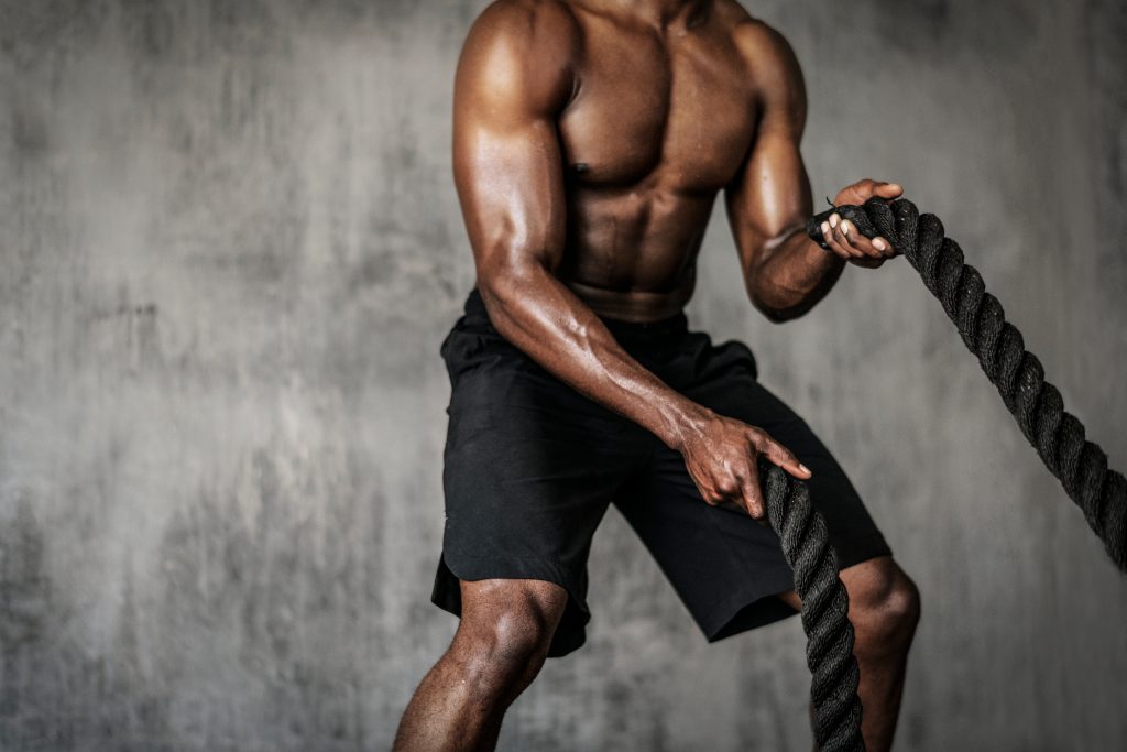 Man performing strength training with ropes
