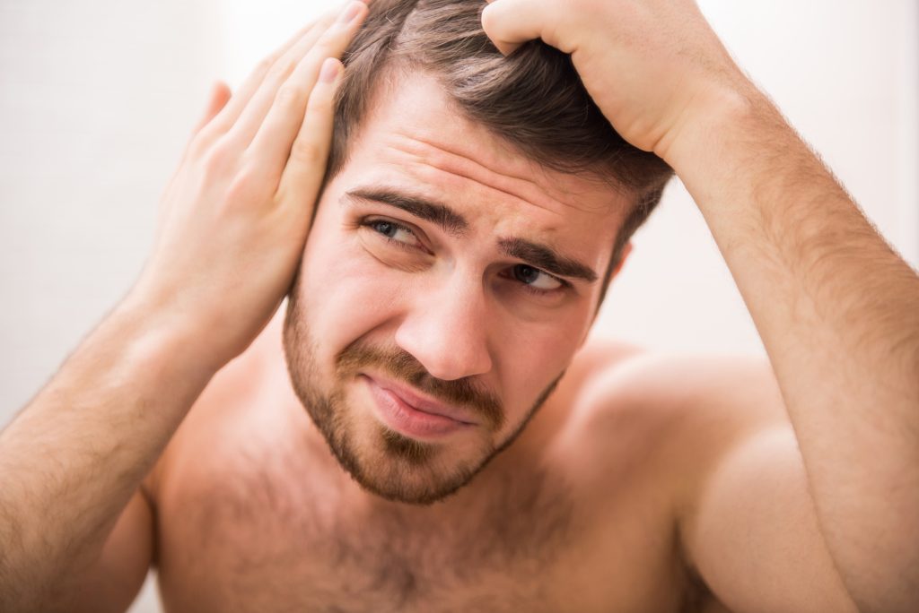 Male hair growth illustration highlighting Biotin and hair follicles